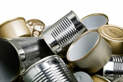 Supervisor reviewing risk assessment paperwork beside a parked skip